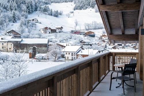 a balcony with a view of a snow covered town at Apart Zwingerhof in Ladis