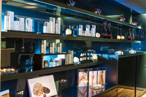 a display case in a store with books at Elounda Beach Hotel & Villas, a Member of the Leading Hotels of the World in Elounda