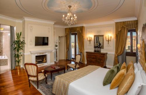 a large bedroom with a bed and a fireplace at Radisson Blu GHR Rome in Rome