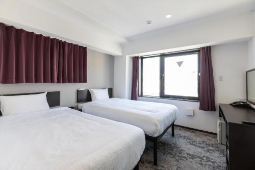 Postel nebo postele na pokoji v ubytování Hotel Tetora Kyoto Station
