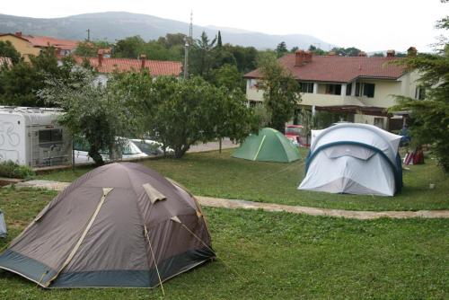 a group of tents in the grass in a yard at Camping Jakomin in Koper