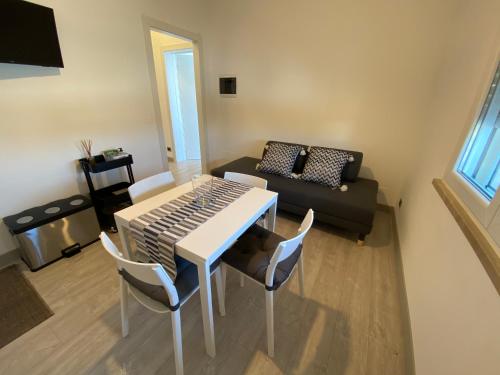 a living room with a table and a couch at Green House in campagna in Melara