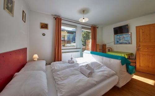 a living room with a white couch and a window at Appartement Schattberg in Saalbach Hinterglemm