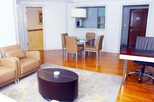 a living room with a table and chairs at Wyndham Casablanca Jakarta in Jakarta