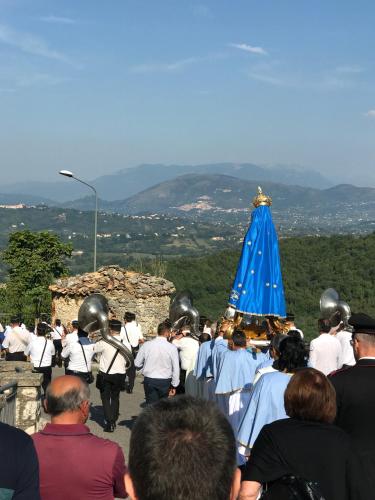 a group of people walking down a street with a group of musicians at Albergo Diffuso Sotto Le Stelle in Picinisco