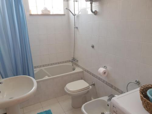 a bathroom with a toilet and a sink and a tub at Casa Vacanze Umberto I in Bova Marina