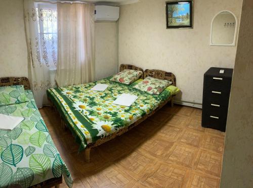 a small bedroom with two beds and a dresser at Гостевой Дом Отдых Мечты in Tsandrypsh