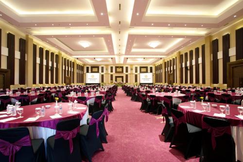 a banquet hall filled with tables and chairs at Grand Sunshine Resort & Convention in Bandung