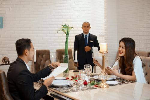 a group of people sitting around a table at Grand Sunshine Resort & Convention in Bandung