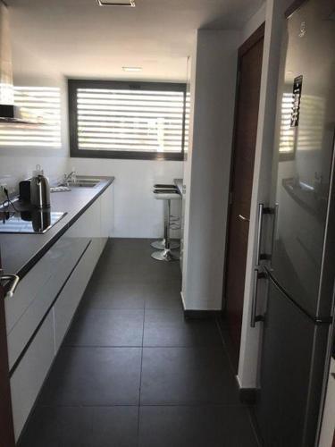 a small kitchen with a sink and a counter at Luxus-Chalet-Casas-Blancas-cases-blanques-1-casa-A in Cala Mendia