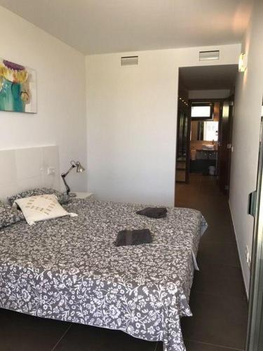 a bedroom with a bed with two pillows on it at Luxus-Chalet-Casas-Blancas-cases-blanques-1-casa-A in Cala Mendia