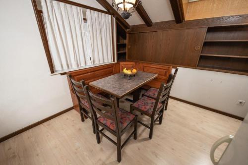 a dining room with a table and chairs and a window at Haus Pickelschmiede in Saas-Grund