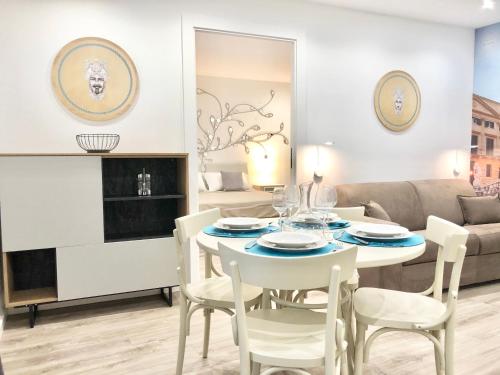 a living room with a table and chairs and a couch at SUITE 4 CANTI in Palermo