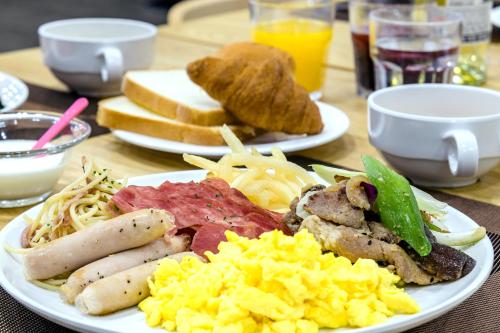 two plates of breakfast food on a table at Shin Shin Hotel Cheonjiyeon in Seogwipo