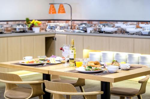 a wooden table with plates of food on it at Shin Shin Hotel Cheonjiyeon in Seogwipo