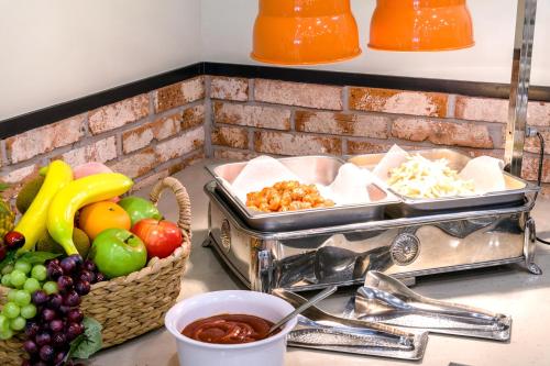 a counter top with a bunch of fruits and vegetables at Shin Shin Hotel Cheonjiyeon in Seogwipo