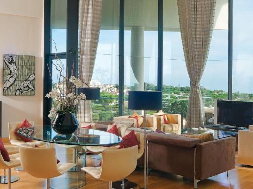 a living room with a couch and a table and chairs at Senator Banus in Estepona