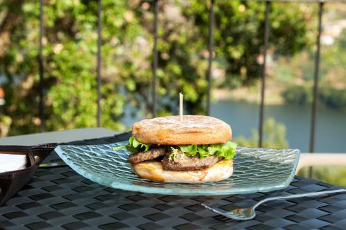 a sandwich sitting on a plate on a table at Douro Palace Hotel Resort & SPA in Baião