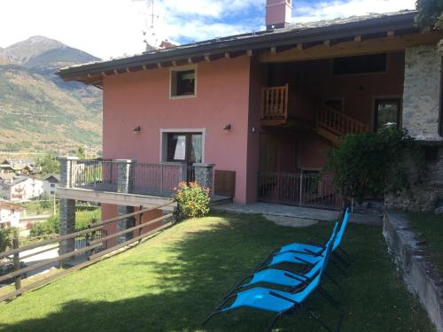 a house with a row of kayaks in the yard at La Maison De Deni in Aymavilles