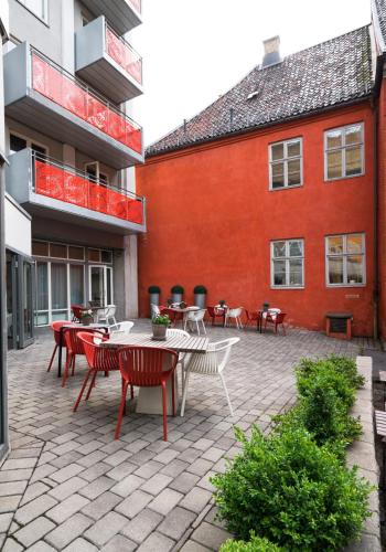 a patio with tables and chairs in front of a building at Thon Hotel Panorama in Oslo