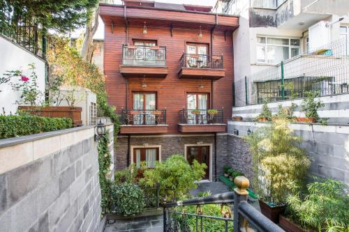 
a large building with a balcony and a garden at Rose Garden Suites in Istanbul
