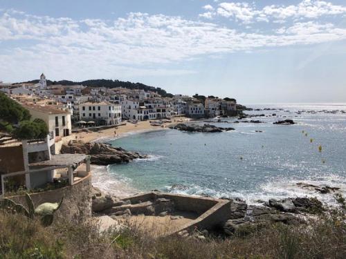 a view of a beach with houses and the ocean at Hotel Mediterrani in Calella de Palafrugell