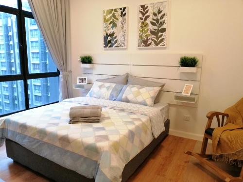 a bedroom with a bed and a window at NORDIC Geniehome2BR1studio Free 90mbps WIFI and Carpark at Utropolis Suite Shah Alam in Shah Alam