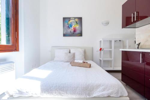 a white bedroom with a white bed and a sink at Alessia's Flat - Certosa in Milan