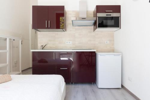 a small kitchen with a sink and a refrigerator at Alessia's Flat - Certosa in Milan