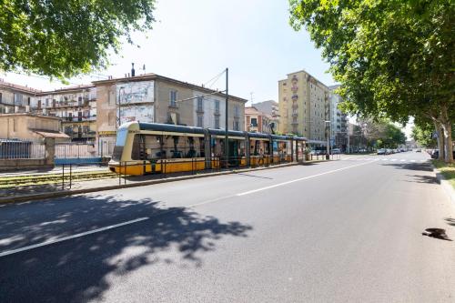 a bus is parked on the side of a street at Alessia's Flat - Certosa in Milan