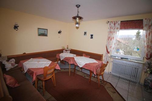 ein Zimmer mit zwei Tischen und einem Sofa in der Unterkunft Gästehaus Schreiner in Sankt Oswald