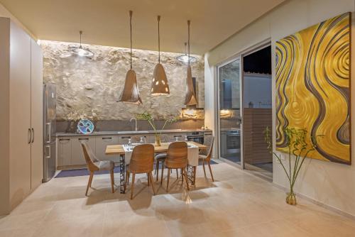 a dining room with a table and chairs at Gaia Blue Villa in Kolymbia