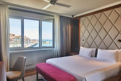 a hotel room with a bed and a window at Hotel Silken Palacio Uribarren in Lekeitio