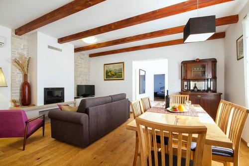 a living room with a table and a couch at Villa Krmed in Krmed