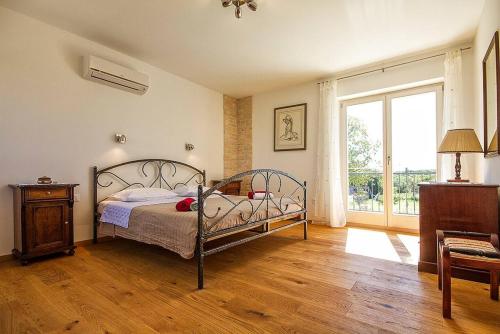 a bedroom with a bed and a large window at Villa Krmed in Krmed
