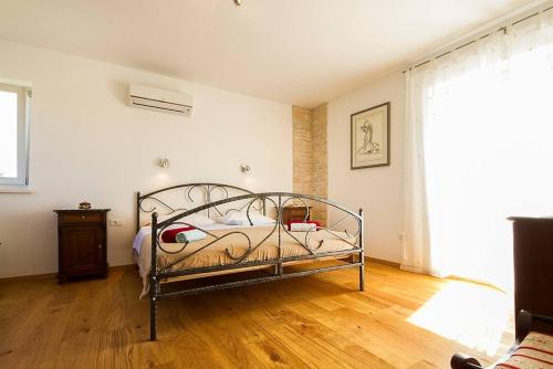 a bedroom with a metal bed in a room at Villa Krmed in Krmed