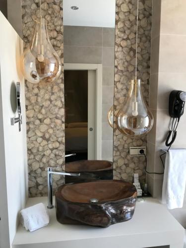 a bathroom with a sink and a mirror at Hotel Galería Essentia in Aracena