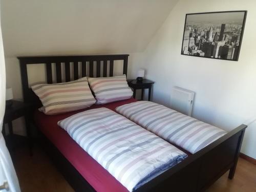 a bed with two pillows on it in a room at Haus Daniela in Rust