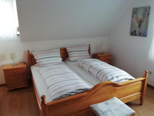 a bed with two pillows on it in a room at Haus Daniela in Rust