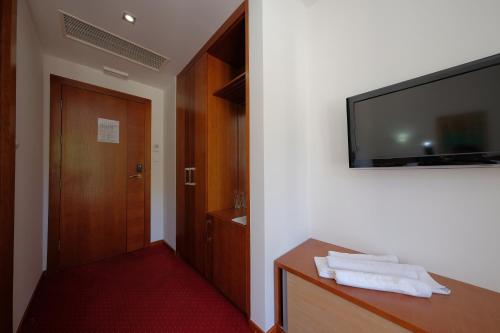 a hotel room with a television on a wall at Motel Mujanic Sarajevo in Sarajevo