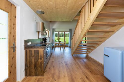 a kitchen with wooden stairs and a dining room at Niederauer Hof in Neubeuern