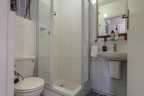 a bathroom with a shower and a toilet and a sink at 9 Bronze Bay in Durban