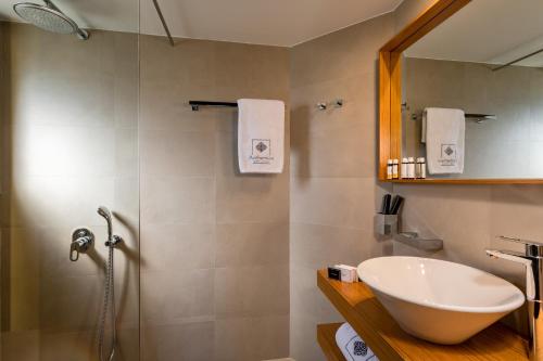 a bathroom with a sink and a shower at Anthemion Suites and Villas in Nafplio