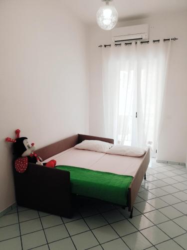 a bedroom with a bed with a green mattress at casa vacanza cilento PARDALIS in Agropoli