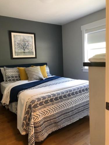 a bedroom with a bed and a window at Bambury's Hillside Chalets in Rocky Harbour