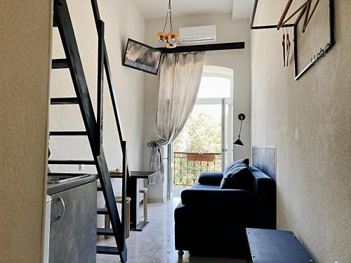 a living room with a black couch and a staircase at Marinesko Apartments in Odesa