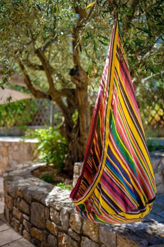 a colorful umbrella hanging on a stone wall at Anthemion Suites and Villas in Nafplio