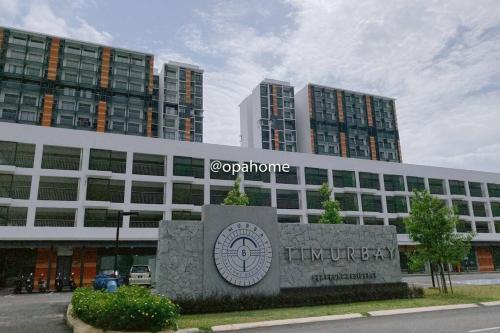 a building with a sign in front of it at OPAHOME@ Timurbay Seafront Residence 2BR Family suite Seaview and Poolview in Kuantan