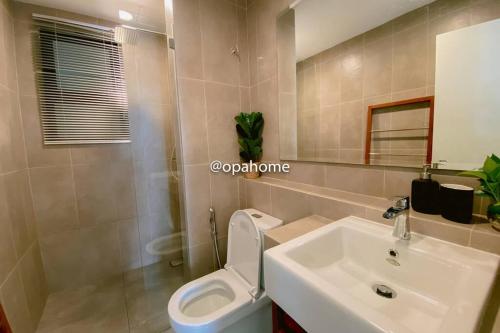 a bathroom with a white toilet and a sink at OPAHOME@ Timurbay Seafront Residence 2BR Family suite Seaview and Poolview in Kuantan