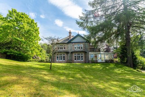 an old stone house with a large yard at Foyers Bay Country House in Foyers